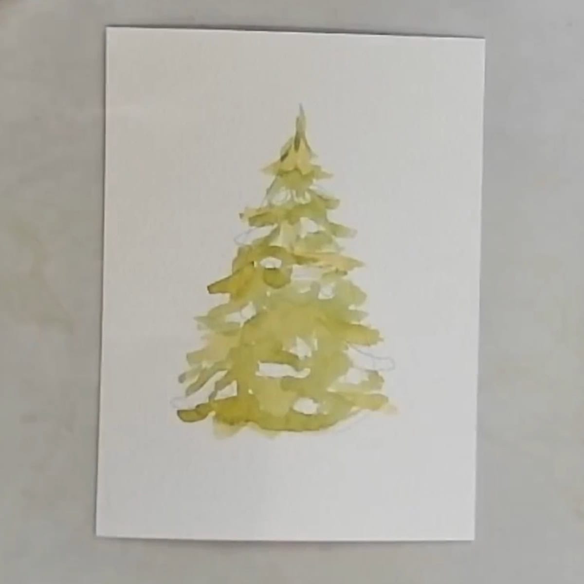 A Christmas tree painted with one layer light green watercolor paint.