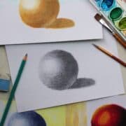 spheres created in pencil, watercolor paint and soft pastels with paints, paint brushes and drawing pencils