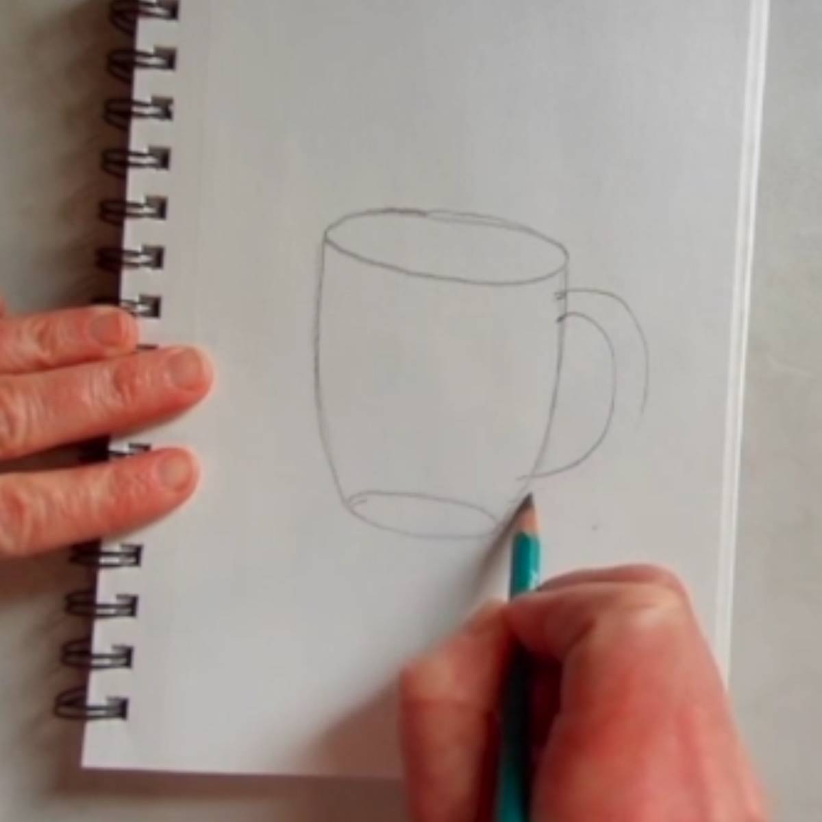 Beginning sketch of a coffee mug in pencil with the handle added in.