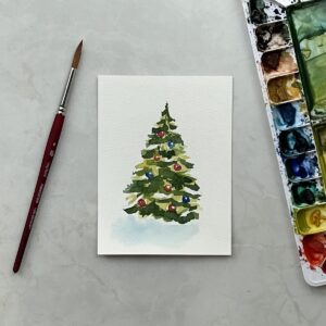 A watercolor painting of a Christmas tree next to a paintbrush and palette.