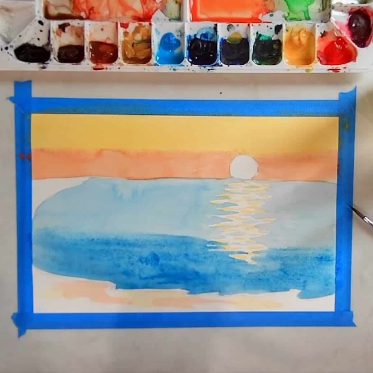 A watercolor beach sunset painting in progress.